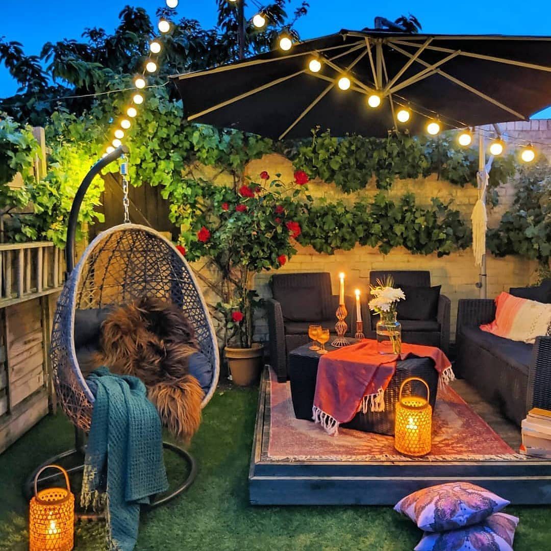24 Stunning Boho Patio Ideas That Wow in 2025 2 Evening Bloom Under Lights - Boho Patio Decor Ideas