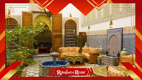 Moroccan-style patio with ornate lanterns, poufs, and richly patterned rugs