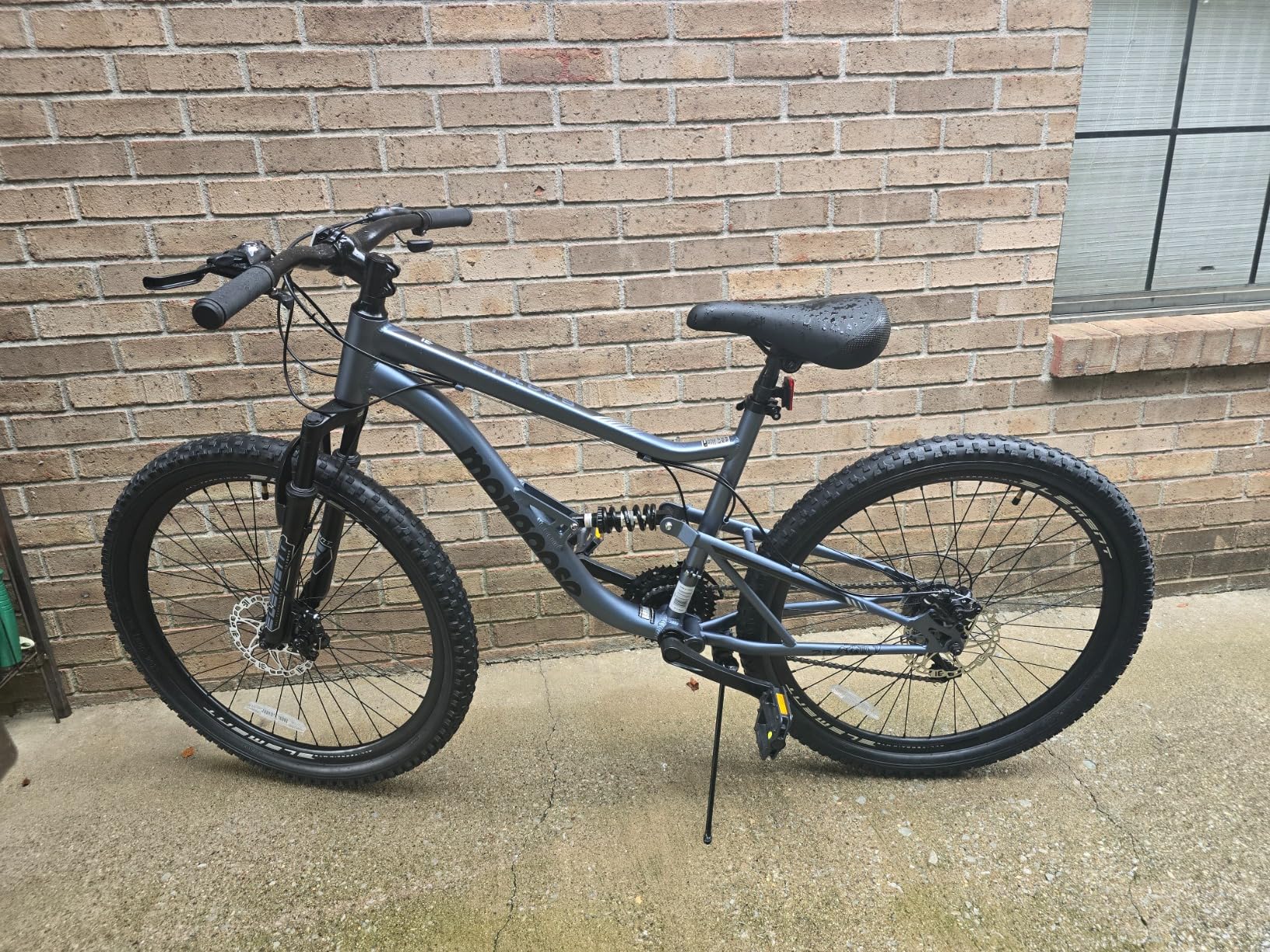 Mongoose Status Mountain Bike, 26 Inch Bike for Men and Women, 21 Speed, Aluminum Suspension Frame, Steel Rear Triangle, Suspension Fork, Knobby Mountain Tires, Mechanical Disc Brakes, Adult Bicycle customer photo 1