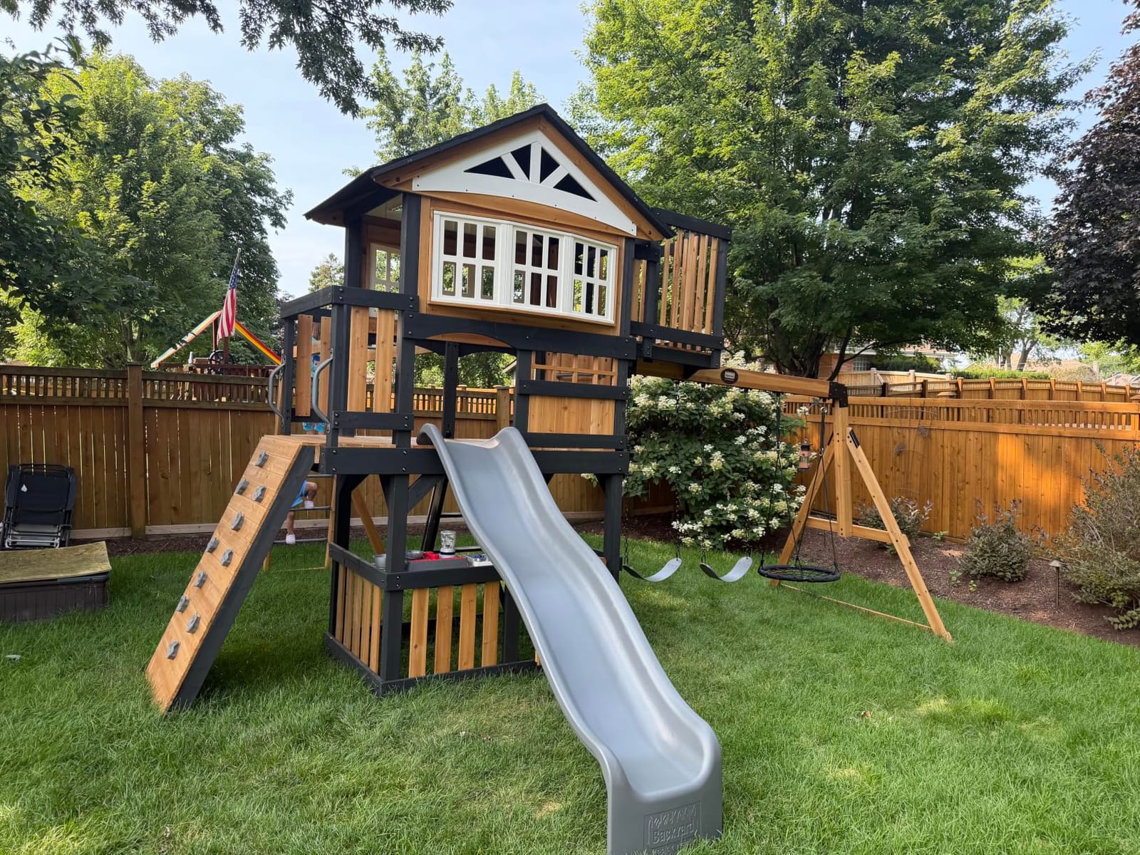 Backyard Discovery Rosewood Falls Cedar Wood Swing Set with Monkey Bars, Clubhouse, Crow's Nest, Play Kitchen, Wave Slide, Rock Wall, Belt Swings, Web Swing, Half Door, Chalkboard, Outdoor Playset customer photo 1